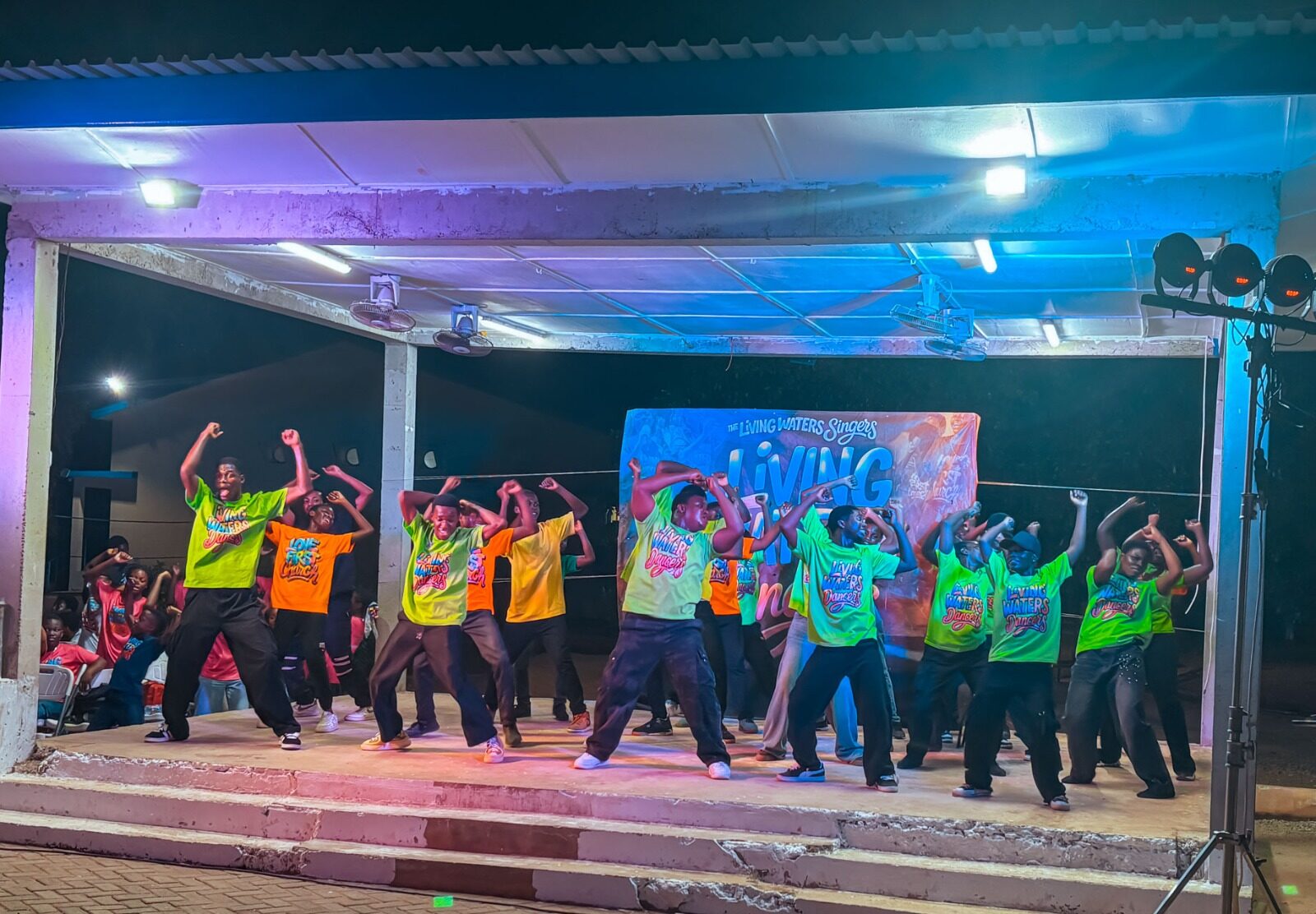 Living Waters Dancers in colourful uniforms on stage
