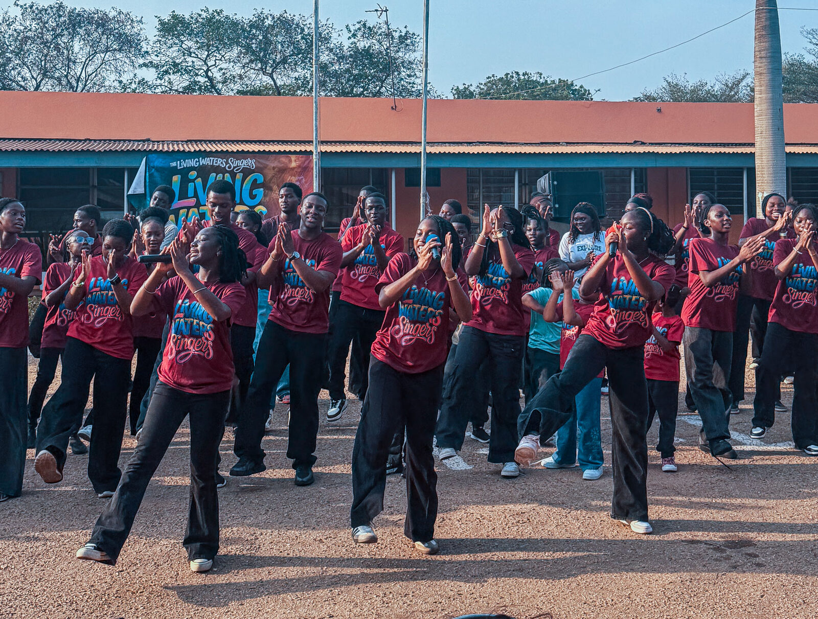 Living Waters Singers performing outdoors in red uniforms